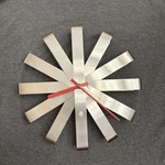 Umbra Ribbon Modern 12-inch Wall Clock, Stainless Steel Red Hands. Fixed Price $72.92.